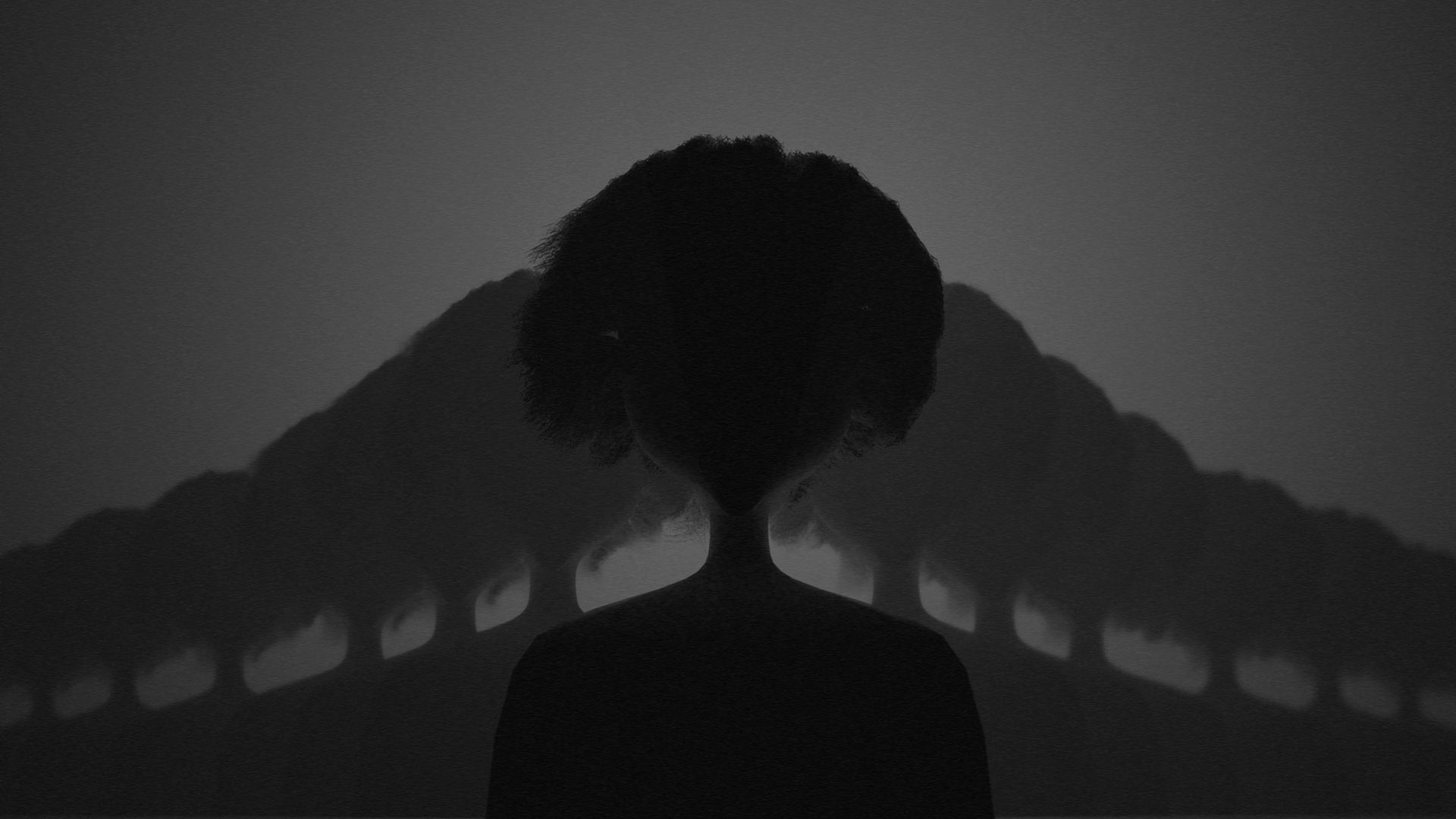 Silhoutte of a figure with copies extending into the distance either side